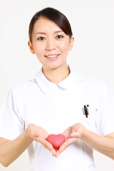 Young Japanese nurse with heart　 — Stock Photo, Image